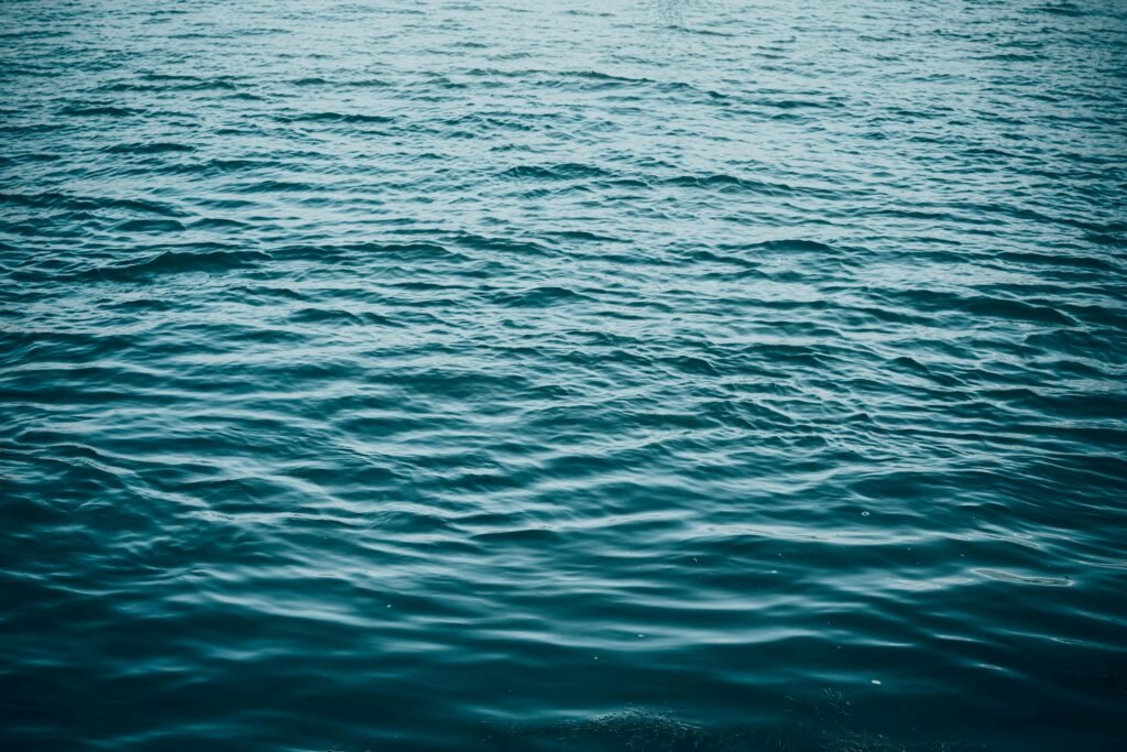 A serene view of blue ocean waves creating a calming texture on the water's surface.